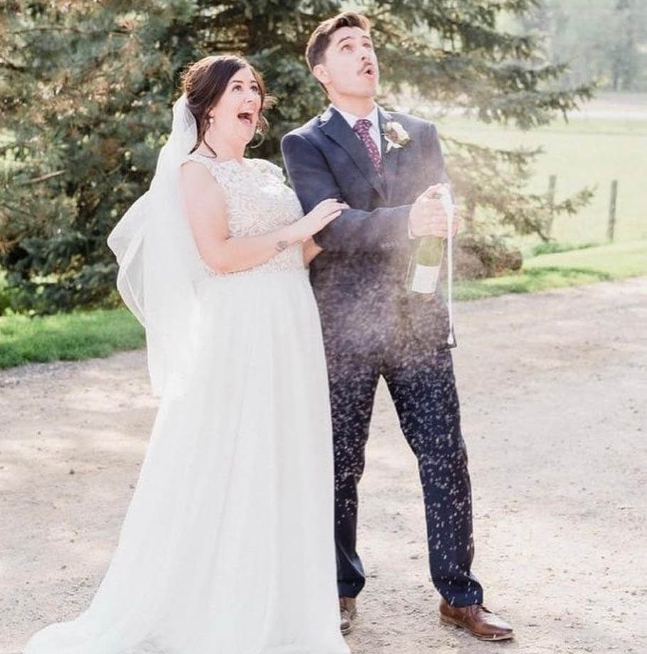 Сouple wearing a white gown and a black suit