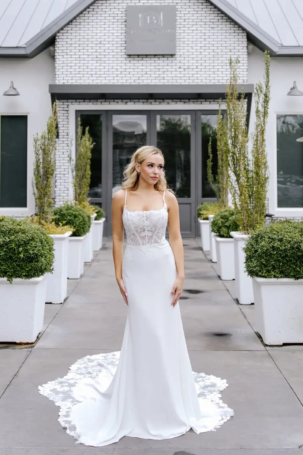 Model wearing a white gown by Stella York