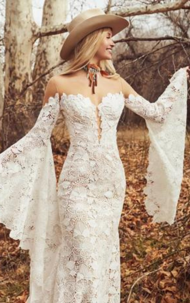 Model wearing a white gown by La Perle