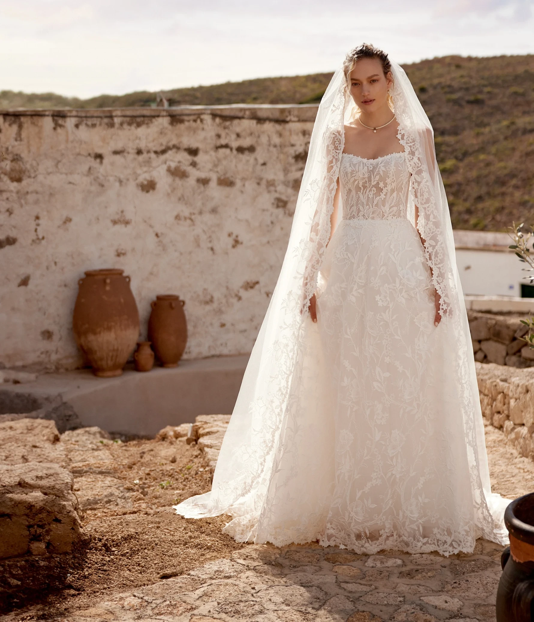Model wearing a white gown by Lillian West