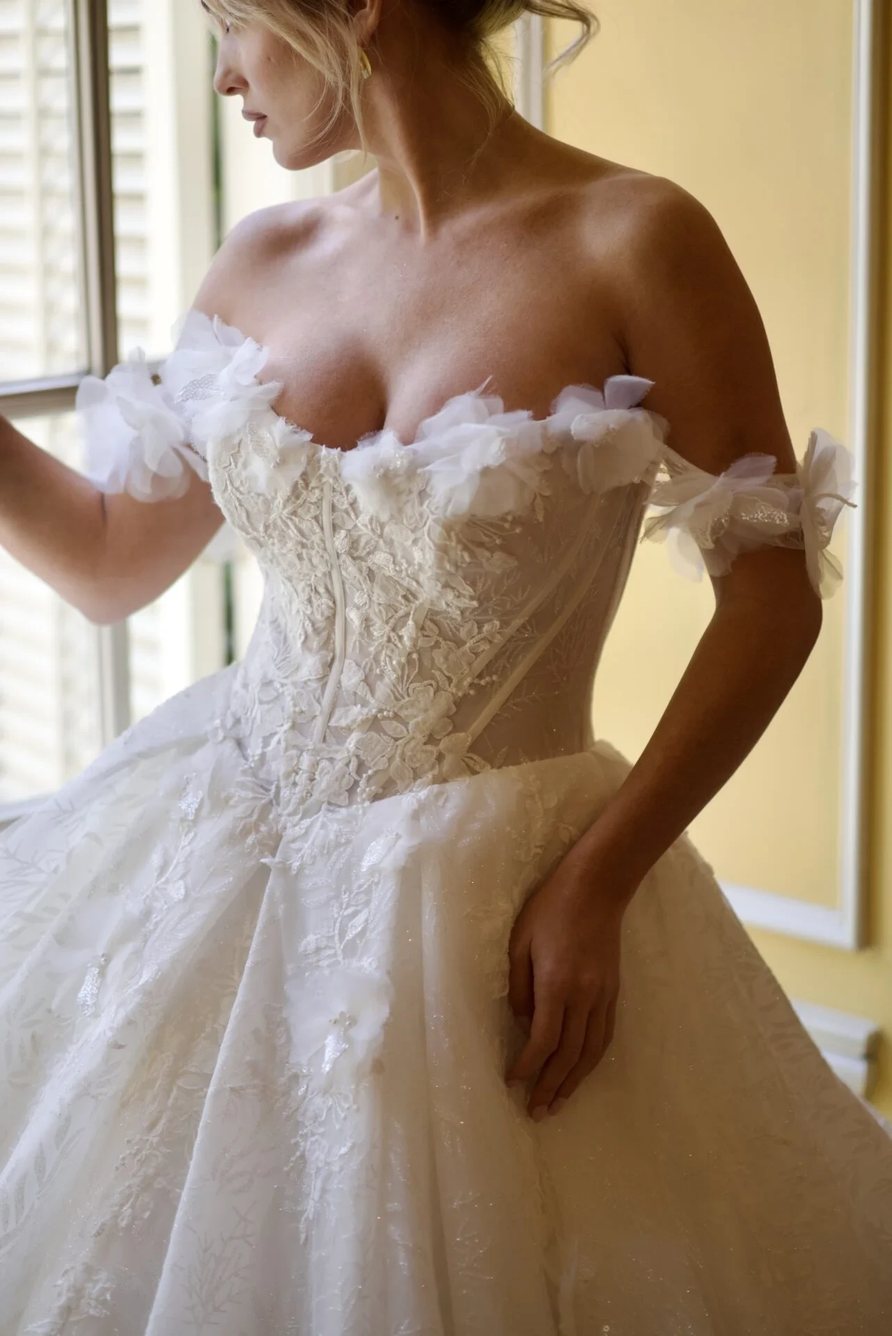 Model wearing a white gown by Martina Liana